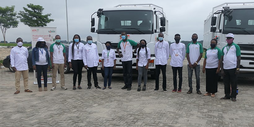 The GoSeed team standing before the trucks.