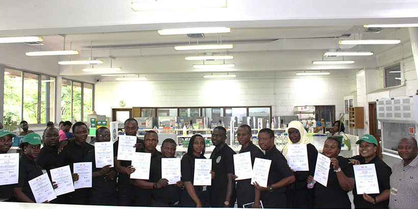 Participants displaying their certificates after the training.