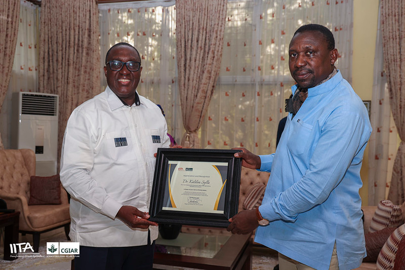 Dr Kalilou Sylla, ECOWAS Honorable Commissioner for Economic Affairs and Agriculture, receiving a recognition and appreciation award from IITA Director General and CGIAR Regional Director for Continental Africa, Dr Simeon Ehui.