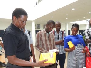 Picture of Media having a feel of IITA’s products during the Media familiarization event.