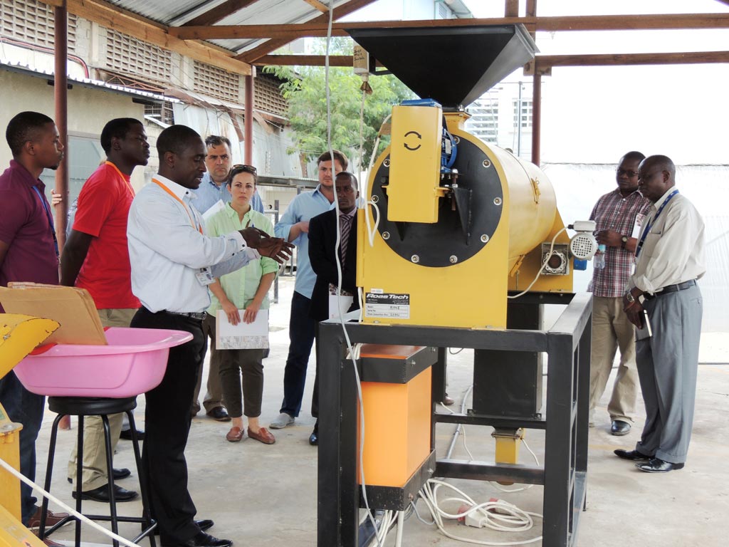 Picture of IITA staff demonstrate to the visiting team the production of AflasafeTZ at IITA-EA hub in Tanzania.