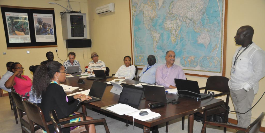 Picture of ATTC Managing Director Abdou Konlambigue (right) leading the discussion with the Aflasafe commercialization team