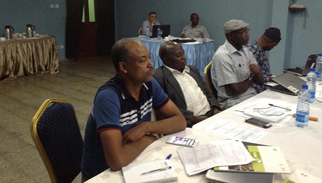 Picture of Chris Akem flanked by Commodity Specialists Sidi Sanyang and Solomon Assefa.