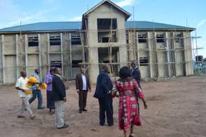 Picture of Tarawali leading the visitors to the Youth Training Center and Agripreneurs’ Work Station that is under construction.