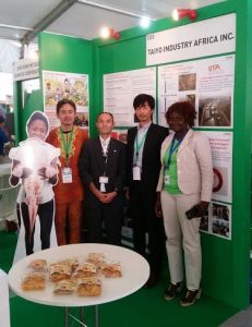 Picture of Youth Agripreneur Elizabeth (far right) with representatives from TIA at the exhibition booth