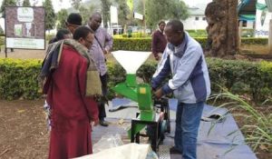 Picture of Ali, a beneficiary farmer from Matufa village-Babati demonstrates how the forage chopper machine operates.