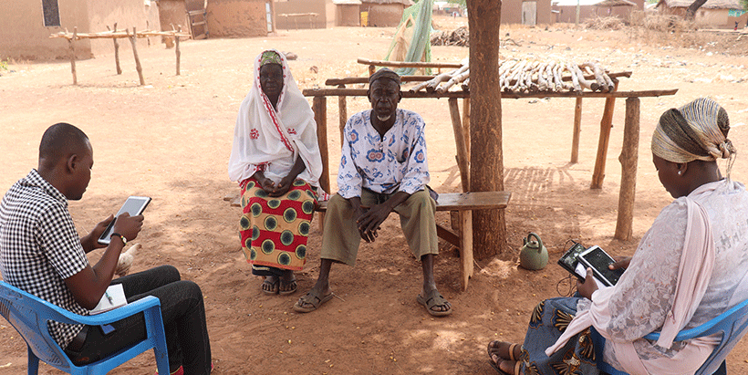 A field supervisor observing an enumerator administering a questionnaire to a couple during the MFS baseline survey in Ghana.
