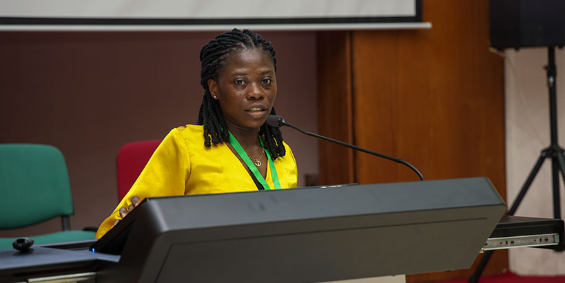 A young researcher giving a summary of her research on underutilized legumes.