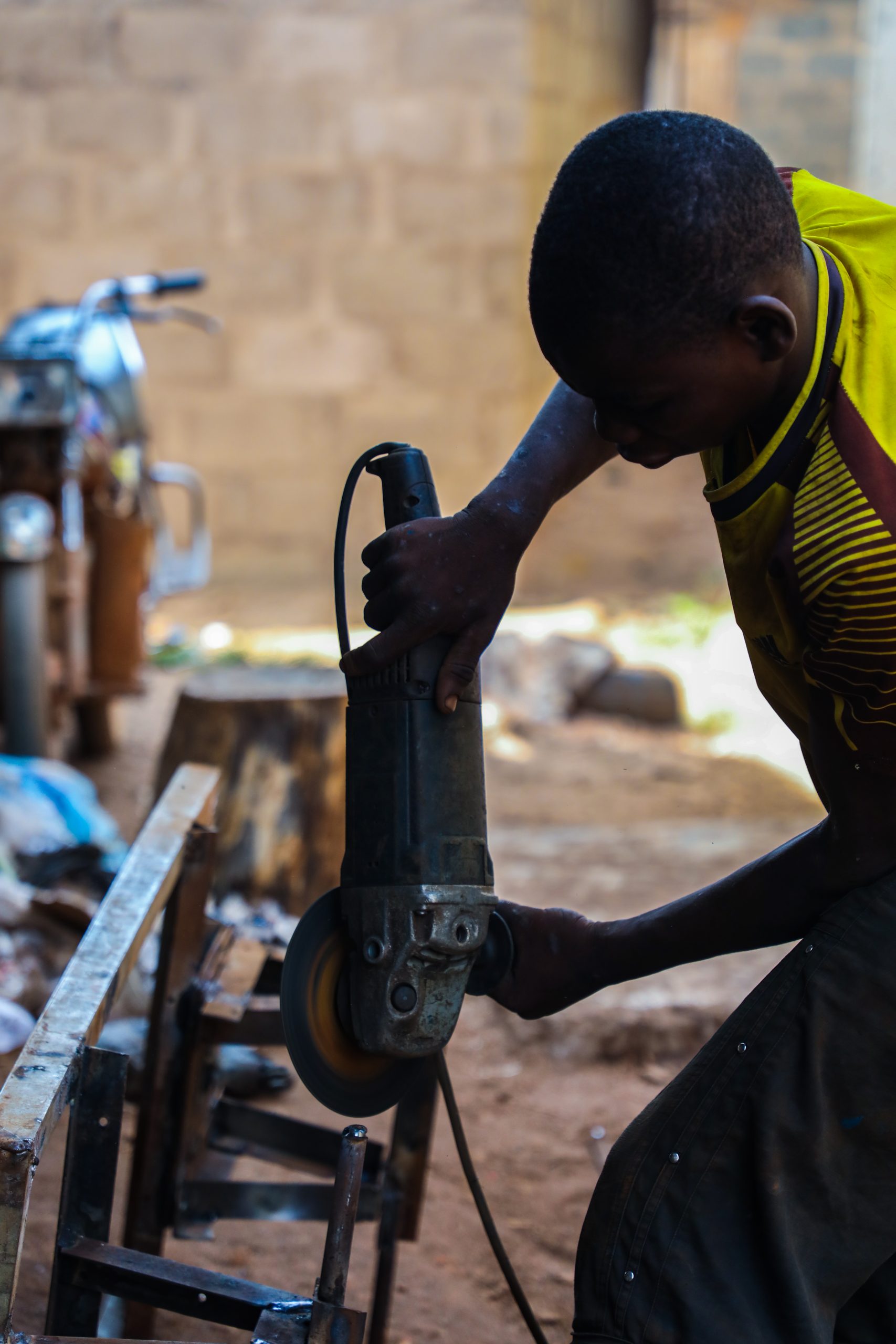 A fabricator trained by Zero Hunger Project trainee working on an equipment to practice the lessons learned.