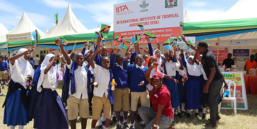  Cheering school children after visiting the IITA booth. Photo: IITA/G. Ndibalema