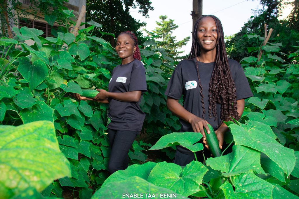 Christelle and Veronique proudly showcasing their freshly harvested cucumbers