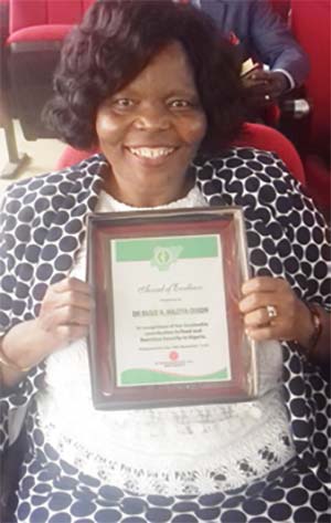 Picture of Dr Busie Maziya-Dixon showing off her plaque