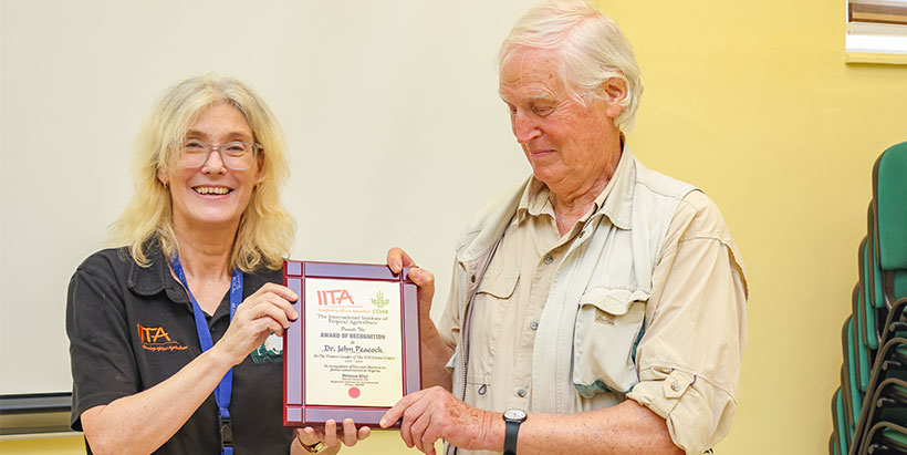 Dr John Peacock receiving an award of recognition from IITA DDG Hilde Koper-Limbourg, as pioneer leader of IITA Forest Center, in recognition of his meritorious contributions to forest conservation in Nigeria.