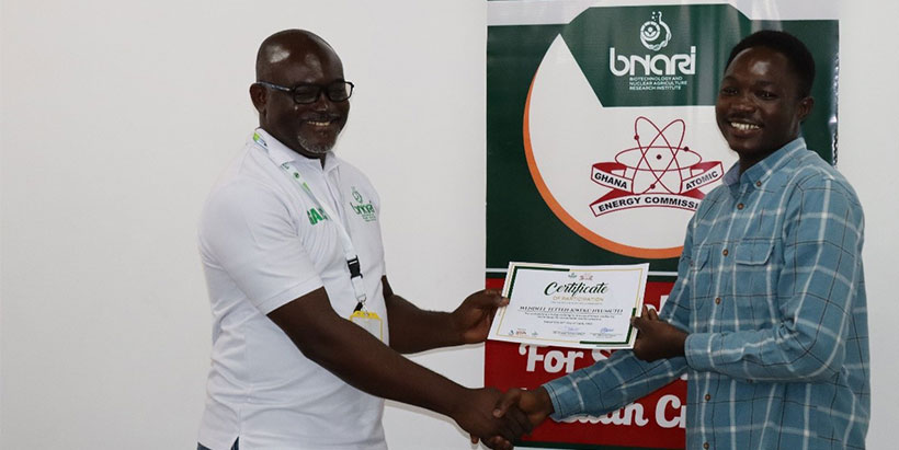 Dr Michael Osae presenting a certificate to a participant at the training