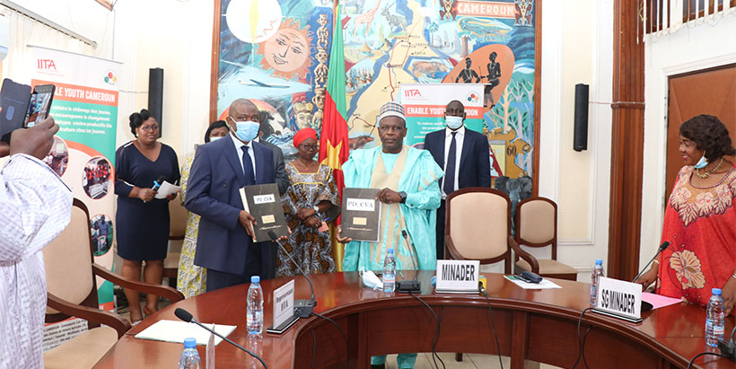 Displaying the signed agreements: Cargele Masso, IITA Country Representative in Cameroon (left) and Honorable Mbairobe Gabriel, Minister of Agriculture and Rural Development.