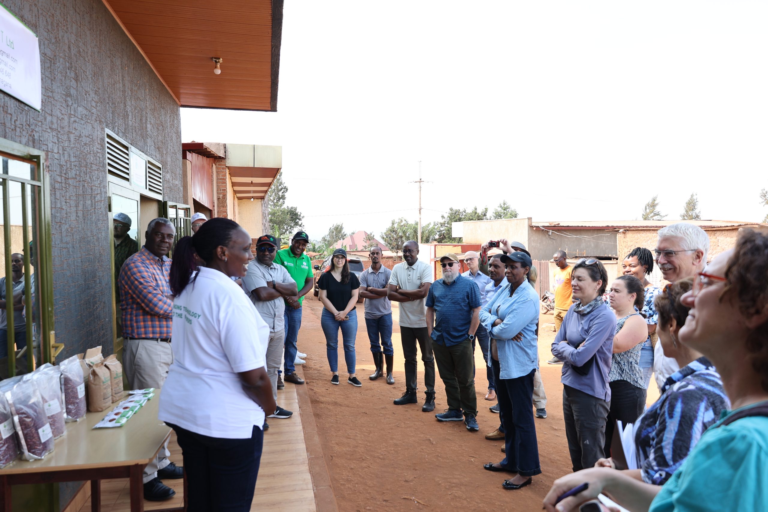 Emma Uwera, standing in front (in a white top), explains her company's role in improving the availability, adoption, and sustainability of the seed system in Rwanda.