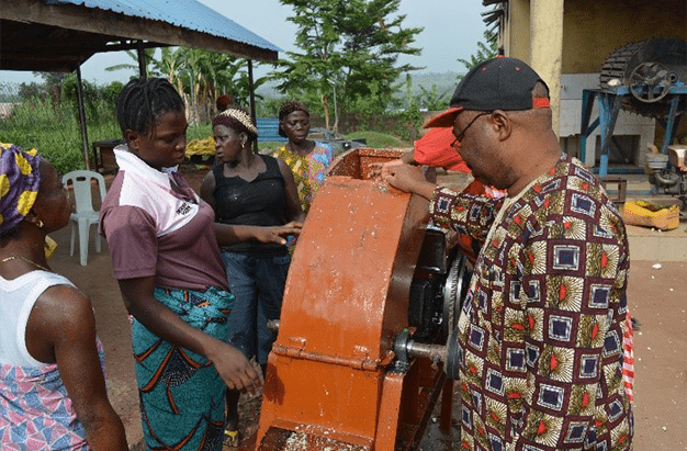 Excited women processors learning how to use the wet hammer mill