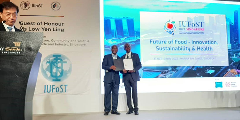 Head of IITA Abuja Station Professor Lateef Sanni on stage (left), accepting the IAFoST fellowship.