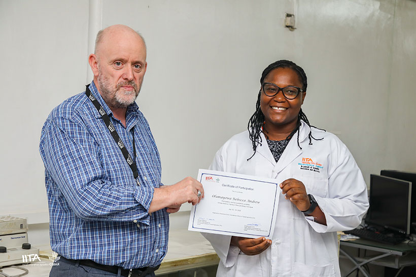 IITA Director for West Africa Hub and Head of the Genetic Resources Center presenting a certificate to one of the participants.