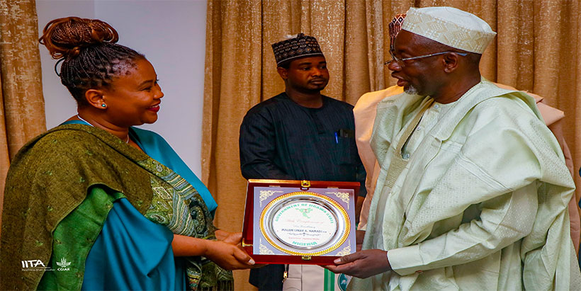 I-Youth Executive Manager, Aline Mugisho presenting a plaque of support recognition to the Executive Governor of Jigawa State, H.E. Mallam Umar Namadi.