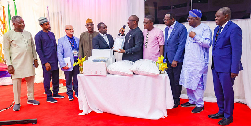 IITA Director General Dr Simeon Ehui handing over packs of Aflasafe to Sierra Leone Minister of Agriculture and Food Security Dr Henry Musa Kpaka.