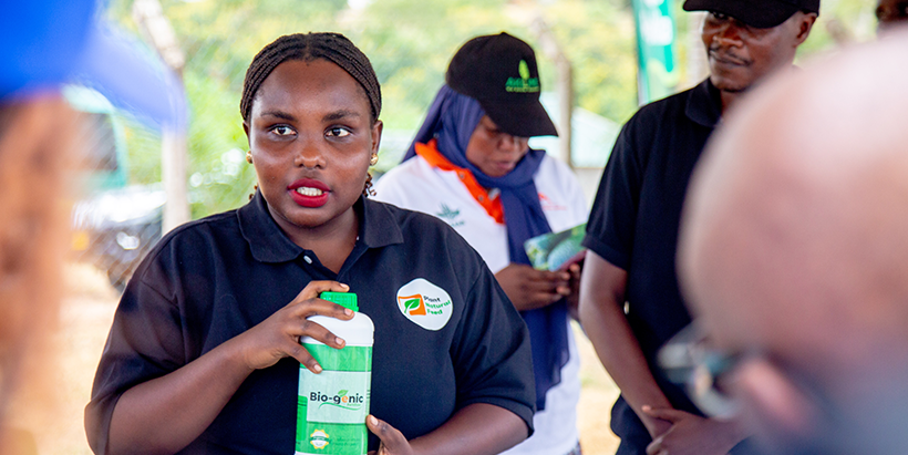 IITA youth beneficiary demonstrates a bio-fertilizer product developed through the program's training and mentorship. (Photo credit: FAO).