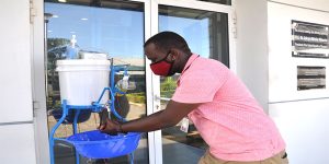 An IITA staff washing his hands before entering the office. This is one of the measures put in place to protect staff from getting COVID-19.