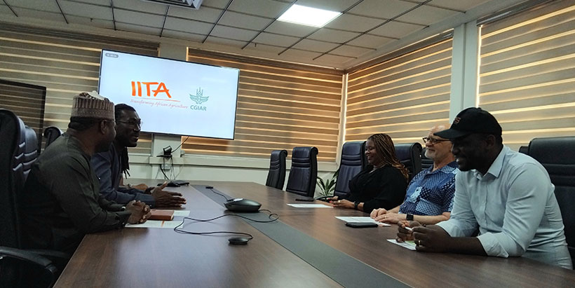  The FAO Country Representative for Nigeria, Koffy Dominique Kouacou engaging in a discussion with Dr. Kenton Dashiell, IITA Deputy Director General Partnerships for Delivery and the IITA team.