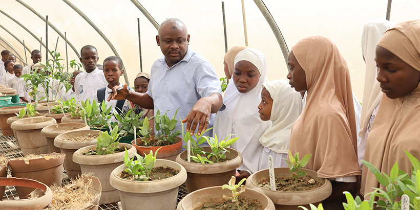 Mansur Sani and students of Cradle to Career in the screen house.
