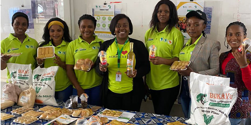 Muriel Mihigo, the coordinator of Kalambo Youth programs and Female youth Agriprenuers displaying their product at the exhibition in Kalambo.