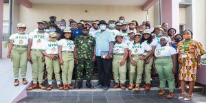 NYSC DG and team in a group photograph with IITA corpers and staff.