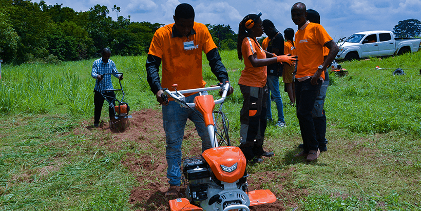 Ewokolo Achiri showing participants how to use the STIHL brush cutter.