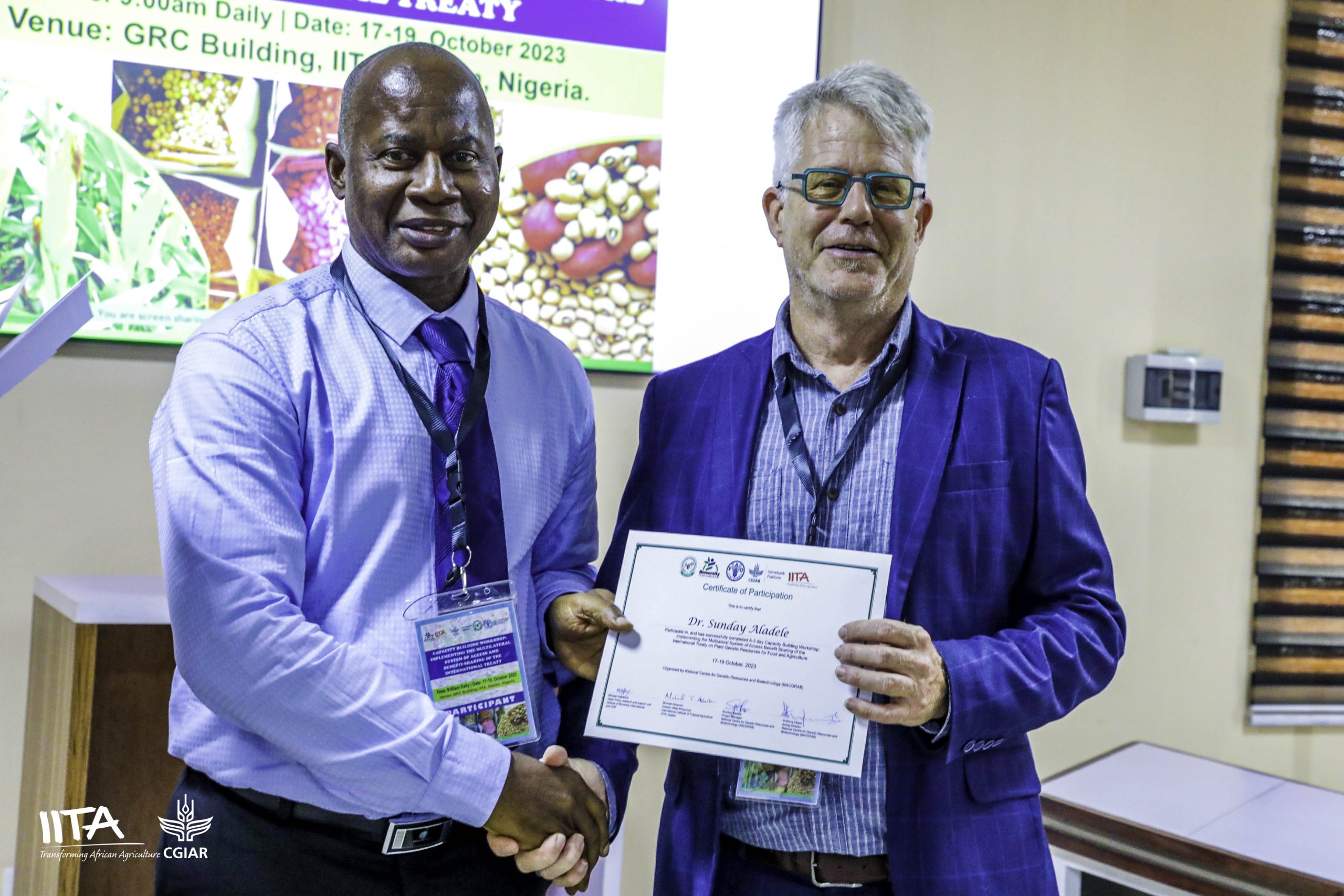 Participants receiving certificate of attendance at the workshop.