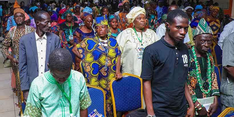 Participants standing for the National Anthem at the start of the conference