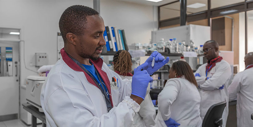 PhD student Duncan Njora conducting molecular analysis in the lab.
