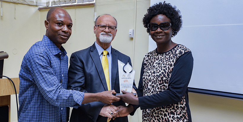President Circularity Africa Dr Olawale Olayide (left) and his colleague presenting the award of excellence to IITA.