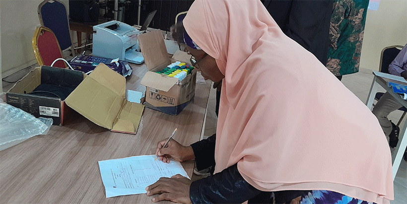 Prof Morufat Balogun signing a document from CSIR-CRI.