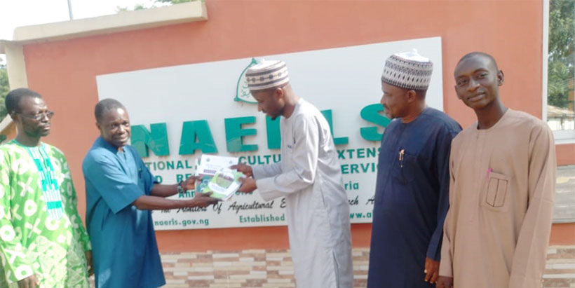 Prof. Paul Bolorunduro presenting NAERLS souvenirs to the visiting SUL President Dr Taofeek Adegboyega while other staff of NAERLS looks on.