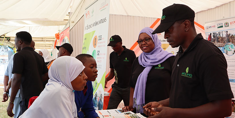 School girls keenly follow the explanation on the aflatoxin by Lab manager Jacob Njela, during the Innovation Week. Photo: IITA/G. Ndibalema