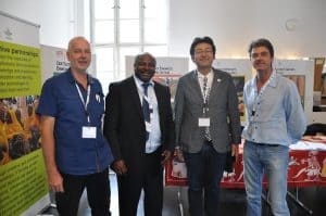 Picture of DG Sanginga (second from left) with IITA staff (L-R), Stefan Hauser, Haruki Ishikawa,  and Danny Coyne at the IITA booth