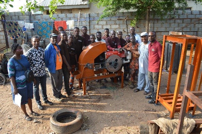 Training participants and the Zero Hunger Project Team showcasing a finished wet hammer mill.