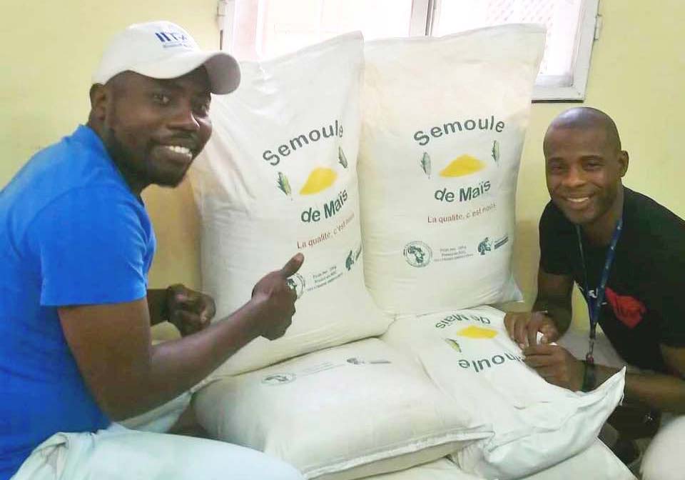 Picture of Two COPAKIN agripreneurs showcasing 25-kg bags of high quality semolina.