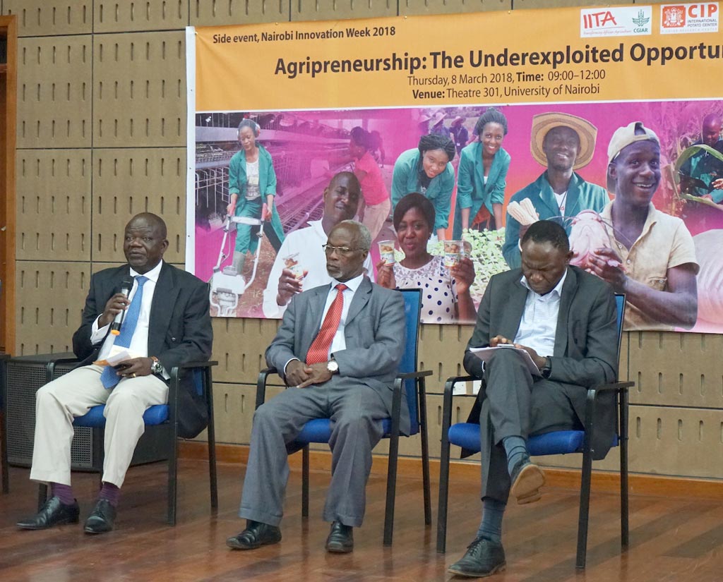 Picture of Victor Manyong speaking during a panel discussion with the keynote speakers.