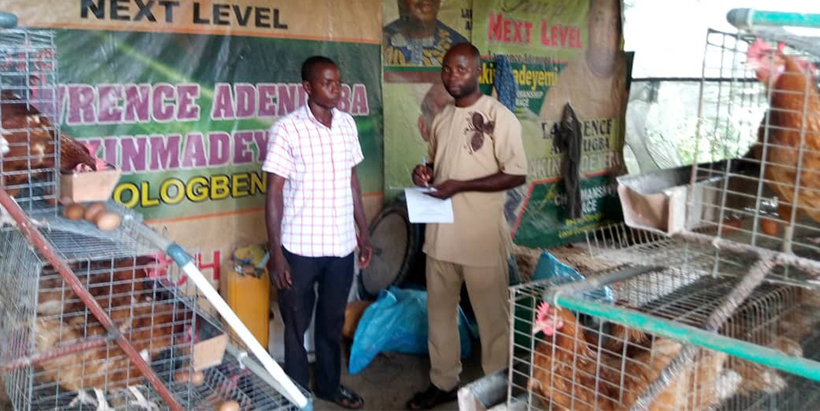 YIAP beneficiary in his poultry farm.