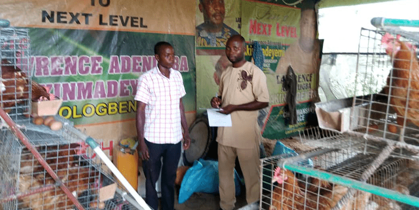 IITA-CARE researcher, Bello, with a respondent during field survey.