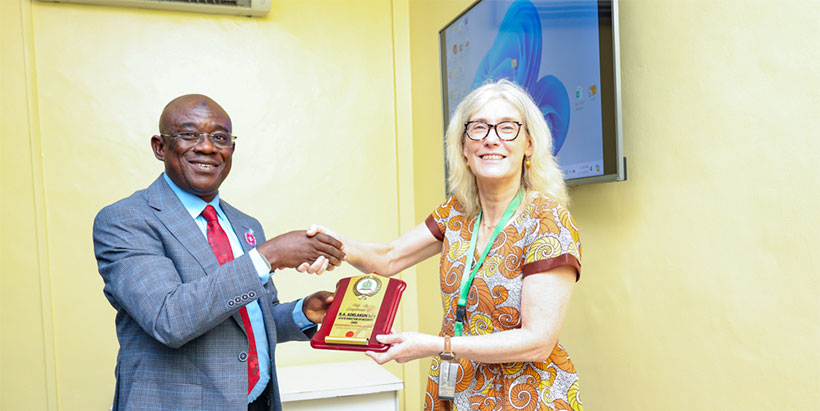 Head of DSS Command, Rasheed Adelakun, presenting an appreciation gift to IITA through IITA Deputy Director General for Corporate Services, Hilde Koper.