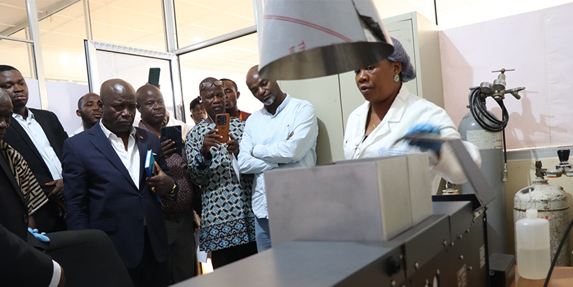 Deputy Minister for Technical Services, Honorable Solomon Hedd-Williams with others at the commissioning of the AAS in the soil testing lab.
