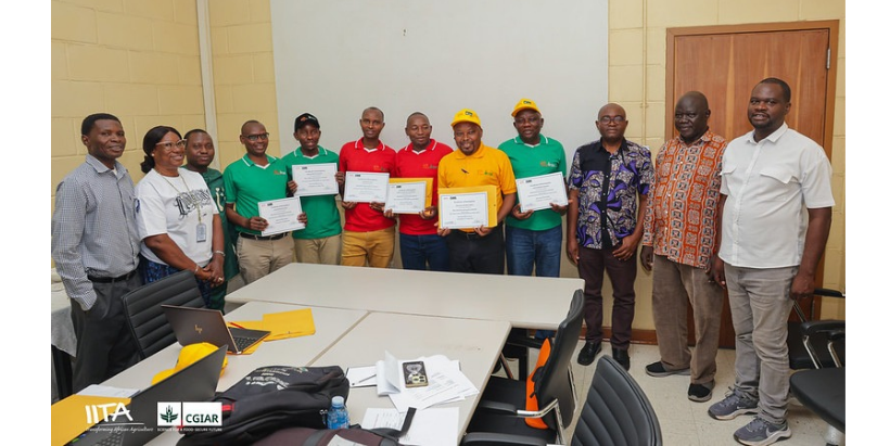 Trainees displaying their certificates of participation at the close of the training alongside facilitators and IITA staff.